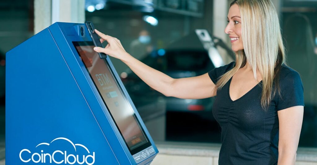 a woman using a coin cloud digital currency atm indoors highlighting modern technology