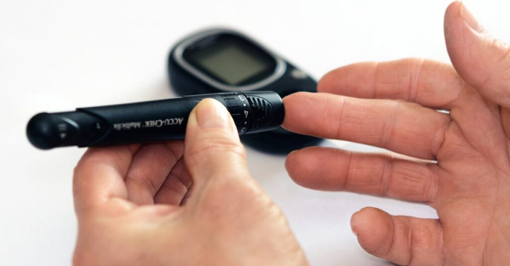 close up image of a person using a glucometer for diabetes management indoors
