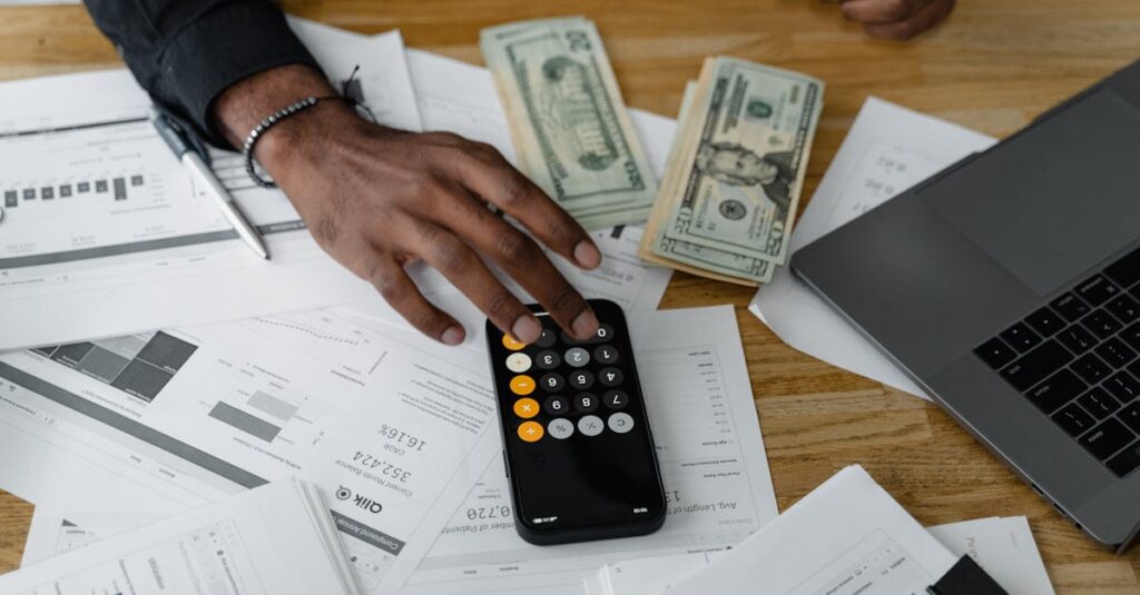 overhead view of financial documents with calculator cash and laptop for financial planning