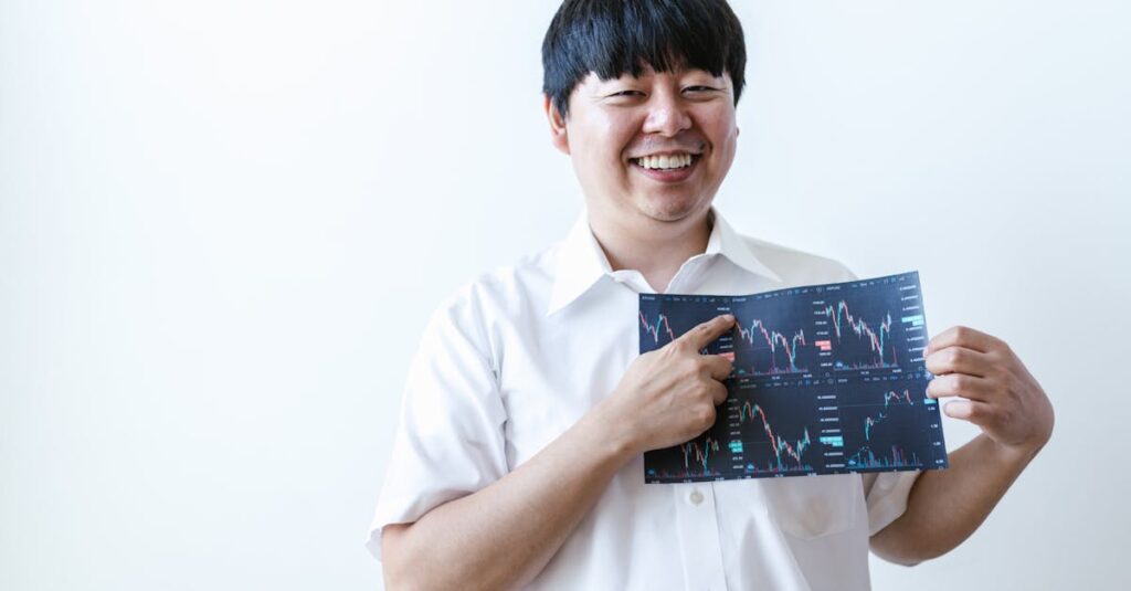 smiling man presenting cryptocurrency investment chart indoors